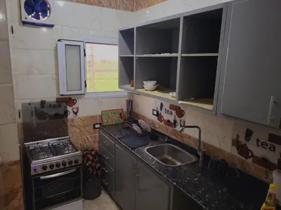a small kitchen with a sink and a stove at Casablanca guest house᭄ꦿ in Luxor