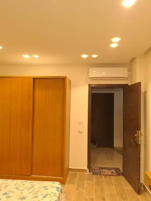 a bedroom with a bed and a door to a hallway at Sahl hashesh Resort in Hurghada