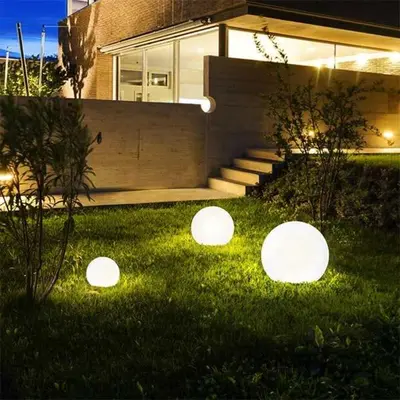 three lights in the grass in front of a house at Sahl hashesh Resort in Hurghada