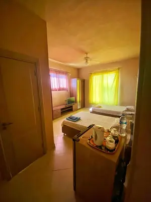 a room with a bedroom with a bed and a table at Luxury Sea-View Villa with Private Pool with Diving center & Beach access in Marsa Alam