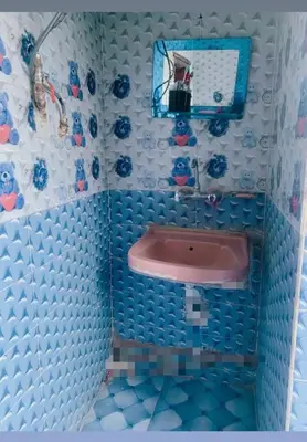 a lego bathroom with a pink sink and a mirror at Nubian night in Jazīrat Suhayl