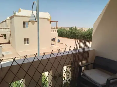 a balcony with a fence and a building at 2 bed rooms apartment in makadi heights in Hurghada