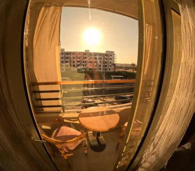a view of a table and chairs from a window at avenue compound in Hurghada