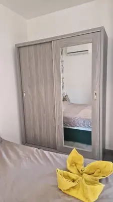 a yellow towel sitting on a bed in front of a mirror at Imperial resort Hurghada, 1 bedroom luxury resort in Hurghada