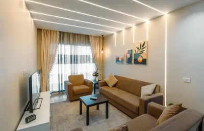a living room with a couch and a chair at Al Saraya Sahl Hasheesh by Peaks One Bedroom Apartment With Pool View C101 in Hurghada