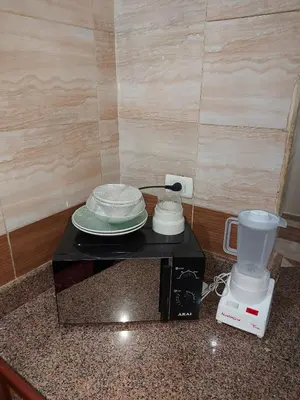 a table with plates and a blender on a counter at Entire hotel apartment overlooking the Nile in Aswan