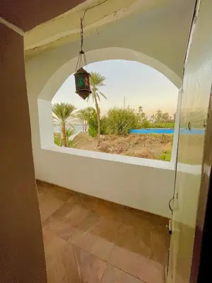 a room with a window with a view of the ocean at Yellow House on the Nile in Luxor