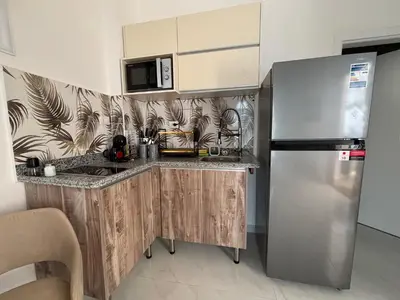 a kitchen with a stainless steel refrigerator and a microwave at Villa Golden Mountain in Luxor