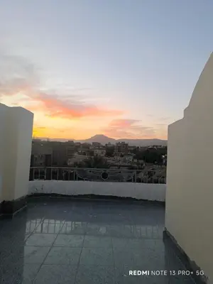 a view of a sunset from a rooftop at King House in Luxor