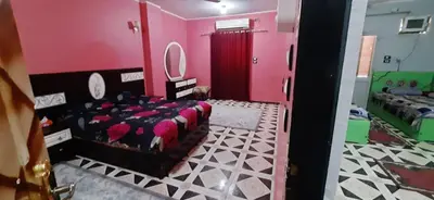 a room with a pink room with a bed and a mirror at Downtown Apartment in Aswan