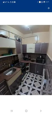 a small kitchen with a sink and a stove at Downtown Apartment in Aswan