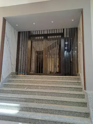 a set of stairs leading into a building with glass doors at Amazing Roof In Marina Hurghada in Hurghada