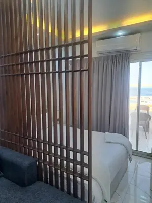 a bedroom with a bed and a balcony with the ocean at Amazing Roof In Marina Hurghada in Hurghada