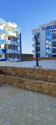a building and a street light in front of a building at Oasis marina in Hurghada