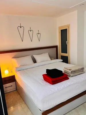 a bedroom with a bed with two hearts on the wall at Apartment in Port Ghalib Marina City in Port Ghalib