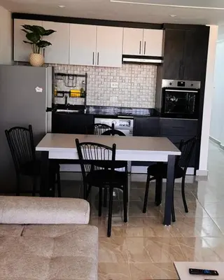 a kitchen with a table and chairs in a room at Apartment in Port Ghalib Marina City in Port Ghalib