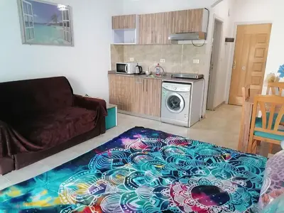 a living room with a couch and a washing machine at Studio Sheraton Plaza in Hurghada