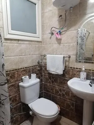a bathroom with a toilet and a sink at Studio Sheraton Plaza in Hurghada