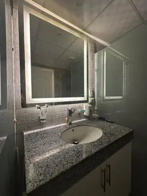 a bathroom with a sink and a mirror at Seafront Hotel Apartment with private beach in Hurghada