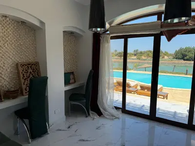 a living room with a view of a pool at NEXT STAY, 3BR Villa, El Gouna in Hurghada