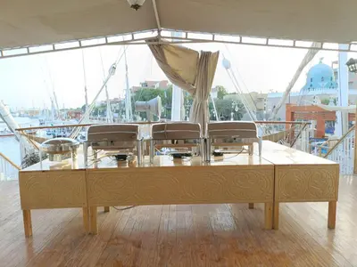 a table on a boat with chairs on it at FayedBasmadahabiya in Luxor