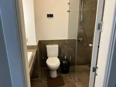 a bathroom with a toilet and a shower at One Bedroom Apartment in El Gouna Bali in Hurghada