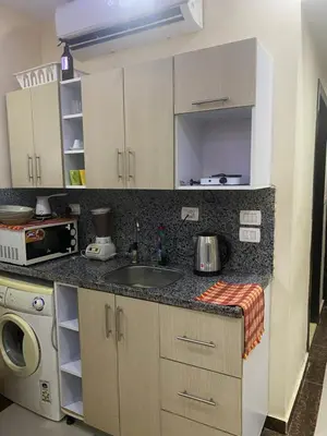 a kitchen with a sink and a microwave at Sea View Apartment Cecelia Resort in Hurghada