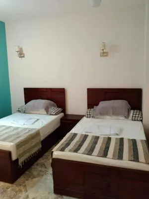 two beds sitting next to each other in a bedroom at Magyipt in Hurghada