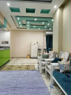 a living room with couches and a rug at Magyipt in Hurghada