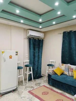 a living room with a couch and a refrigerator at Magyipt in Hurghada