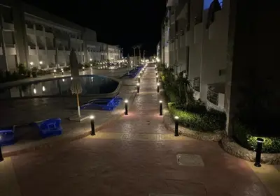 a courtyard with a swimming pool at night with lights at Luxury Cecelia resort in Hurghada