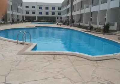 a large swimming pool in front of a building at Luxury Cecelia resort in Hurghada