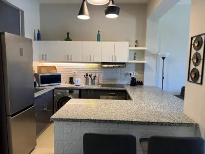 a kitchen with a sink and a refrigerator at NEXT STAY, Lagoon Townhouse, El Gouna in Hurghada