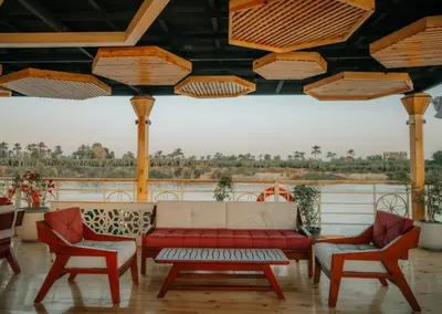 a living room with a couch and two chairs at Azhar Dahabiya luxury suites in Esna