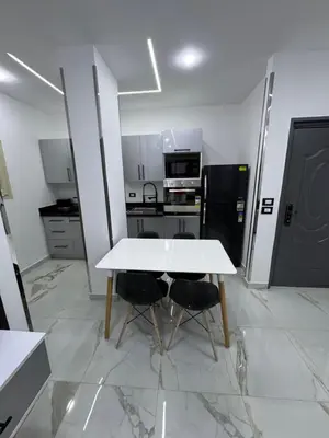 a kitchen with a white table and two chairs at Blue Pearl 203 1BR in Hurghada