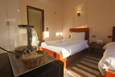 a hotel room with a bed and a fish tank at Golden Land in ‘Ezbet Abu Ḥabashi