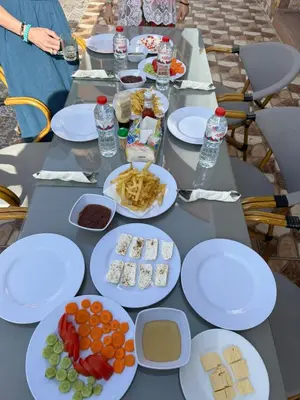 a table with white plates of food on it at Golden Land in ‘Ezbet Abu Ḥabashi