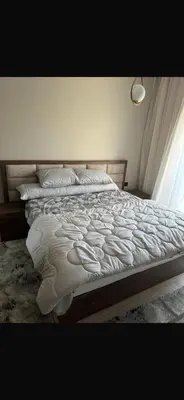a bed with white sheets and pillows in a bedroom at Hurghada in Hurghada