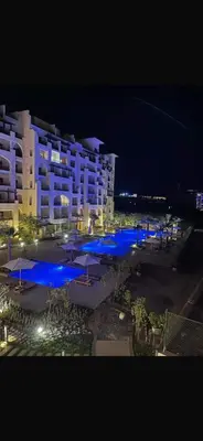 a view of a hotel at night with blue lights at Hurghada in Hurghada