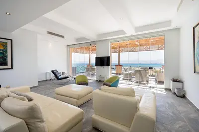 a living room with white furniture and a view of the ocean at VESTA - Soma Bay Residence in Hurghada
