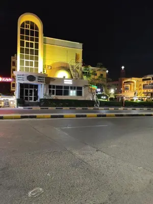 an empty street in front of a building at night at Chalet for rent near the sea Services and tourist walkway in Hurghada