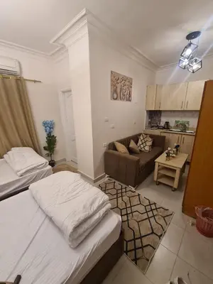 a room with two beds and a couch in it at Chalet for rent near the sea Services and tourist walkway in Hurghada