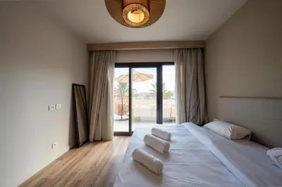 a bedroom with a large bed with a large window at Elegant Fanadir Marina 2BR • Ground Floor in Hurghada