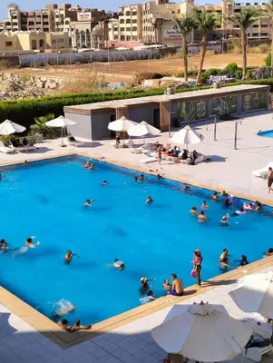 a group of people swimming in a large pool at Scandic Resort Hurghada in Hurghada