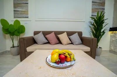 a plate of fruit on a table in a living room at Nile Crown Luxor in Luxor