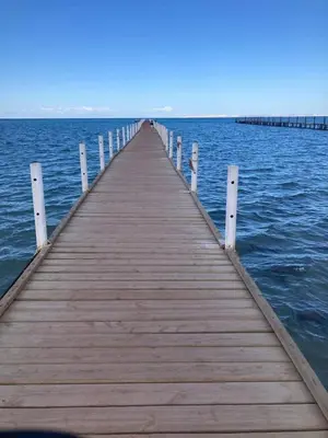 a wooden pier in the middle of the water at كومباوند فوكس هاوس in Hurghada