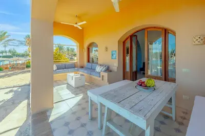 a living room with a table with a bowl of fruit on it at Rihanna apartment direct to the sea in Hurghada