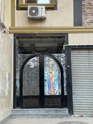 a door with a colorful gate on a building at Comfortable & Modern Appartement in Luxor