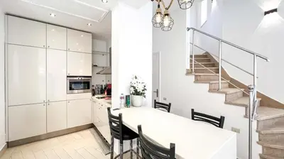 a kitchen and dining room with a white table and chairs at Beachfront Apartment Somabay in Hurghada