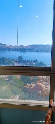 a view of a window with a view of a lake at شقة كورنيش النيل 3غرف فيو كامل علي النيل in Aswan